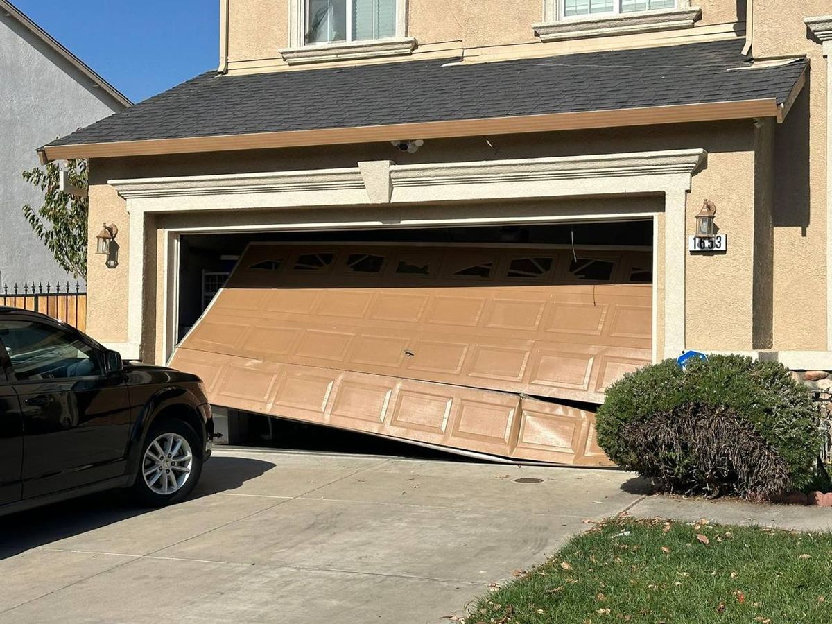 Collapsed garage door being prepared for repair