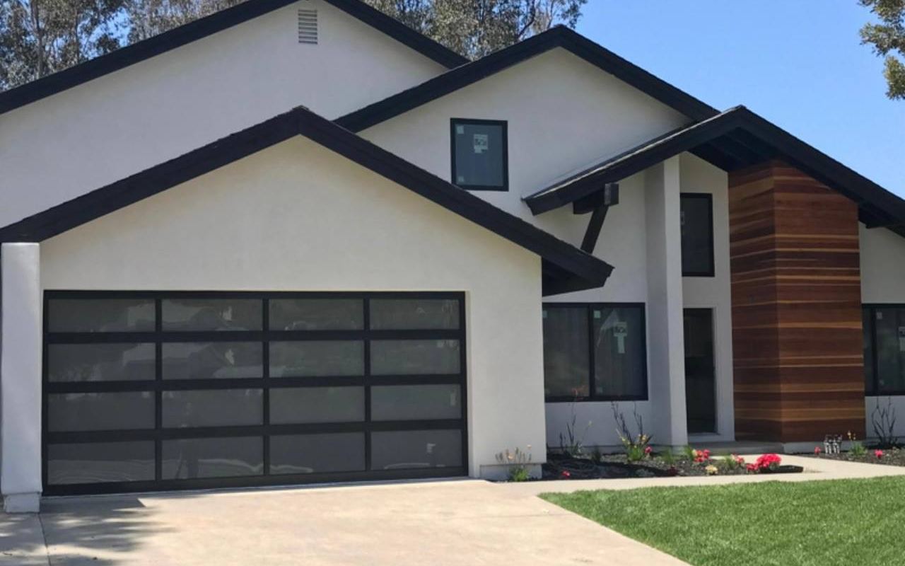 Modern glass-panel garage door on an Arizona home